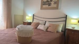 a bedroom with a bed with a basket on it at Residenza Caterina in Bolsena