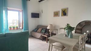 a living room with a table and a couch at Residenza Caterina in Bolsena
