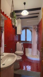 a bathroom with two sinks and two toilets in a room at Residenza Caterina in Bolsena +16 photos