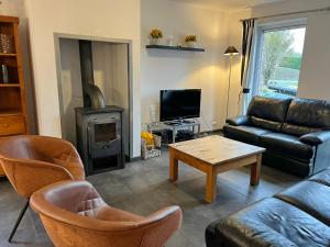 a living room with a couch and a table at Villa Noach in Durbuy