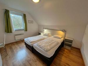 a bedroom with a large bed in a room at Villa Noach in Durbuy