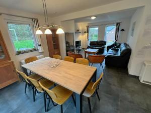 a dining room and living room with a table and chairs at Villa Noach in Durbuy