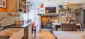 a kitchen and living room with a fireplace at 16th Century Manor House in Richborough