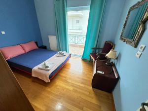 a small bedroom with a bed and a mirror at The Sea View kanali in Kanali