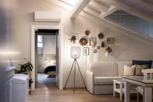 a living room with a couch and a staircase at Bogen bistro & apartments in Bolzano