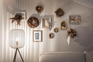 a living room with wreaths on the wall and a couch at Bogen bistro & apartments in Bolzano