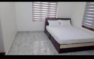 a small bedroom with two beds and a window at Lazars homestay in Fort Kochi