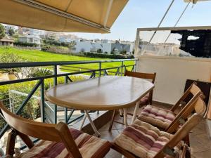 a table and chairs on a balcony with an umbrella at The Sea View kanali in Kanali