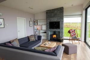 a living room with a couch and a fireplace at Jog Lodge 22 By Together Travel - 3 Bed Sea-View in Wick