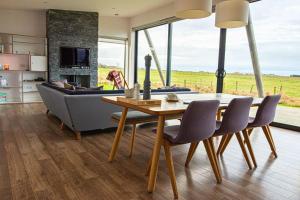 a living room with a table and a couch at Jog Lodge 22 By Together Travel - 3 Bed Sea-View in Wick