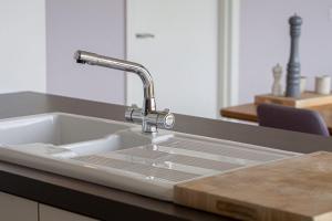 a kitchen sink with a faucet on a counter at Jog Lodge 22 By Together Travel - 3 Bed Sea-View in Wick +24 photos