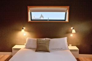 a bedroom with a bed with a window above it at Jog Lodge 22 By Together Travel - 3 Bed Sea-View in Wick