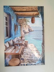 a painting of a room with tables and the ocean at さくらVillaCOAST in Futtsu