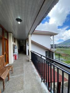 a balcony with a view of a house at Agriya Lubis 2 room in Diyeng