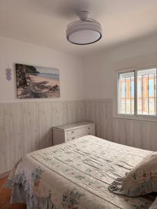 a bedroom with a bed and a window at Casa rural Cristina- Piscina climatizada in Málaga