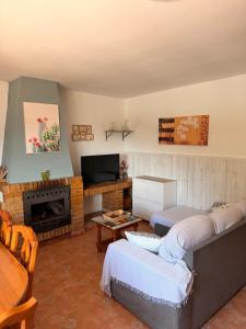 a living room with a couch and a fireplace at Casa rural Cristina- Piscina climatizada in Málaga