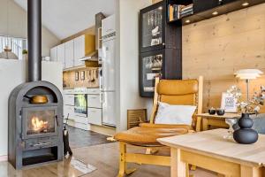 a living room with a wood stove and a table at 740-Hvide-Sande-Slusen-40 in Hvide Sande