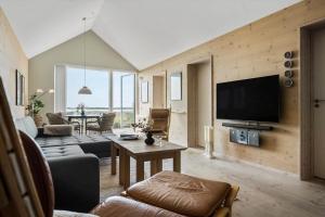 a living room with a couch and a tv at 740-Hvide-Sande-Slusen-40 in Hvide Sande