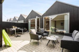 a patio with couches and chairs and a table at 740-Hvide-Sande-Slusen-40 in Hvide Sande