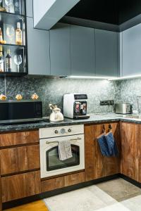 a kitchen with wooden cabinets and a white oven at The Nest in Ruse