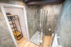 a shower with a glass door in a bathroom at Assarotti Luxury Suite in Genoa +37 photos