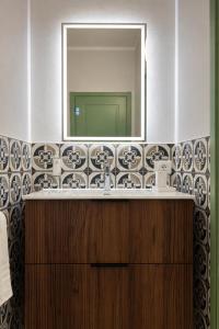 a bathroom with a sink and a mirror at Residence Corte Bizantina in Ravenna +69 photos