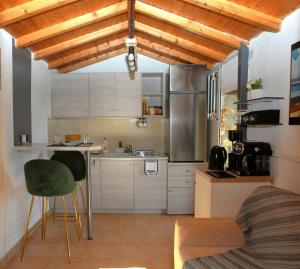 a kitchen with a counter and chairs in a room at Off Grid Romance in Samos in Ireon