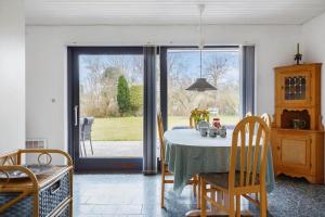 a dining room with a table and a sliding glass door at 3076-Stege-Rusen-16 in Stege +13 photos