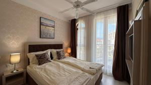 a bedroom with a bed and a large window at Bratanov Harmony Monte Carlo in Sunny Beach +85 photos