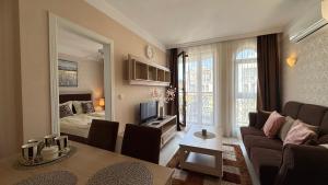 a living room with a couch and a room with a bed at Bratanov Harmony Monte Carlo in Sunny Beach