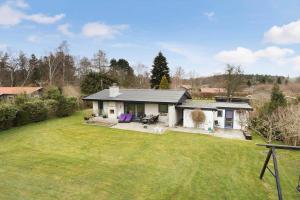 a small white house with a large yard at 3076-Stege-Rusen-16 in Stege