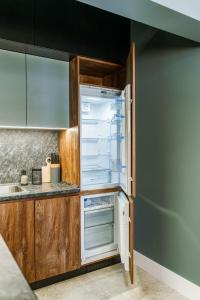 an empty refrigerator with its door open in a kitchen at The Nest in Ruse