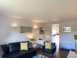 a living room with a couch and a table at Calluna Cottage in Aviemore +2 photos