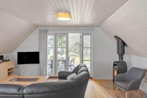 a living room with a couch and a fireplace at 1311-Stege-Rylevej-20 in Stege