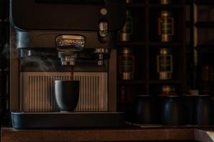 a coffee machine sitting on a counter with a cup at Hotel Seepferdchen Zimmer 2 Eckernförde Self-Check-in in Eckernförde
