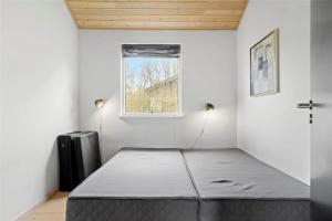 a bed in a room with a window at 1306-Stege-Kaerhogevej-64 in Stege