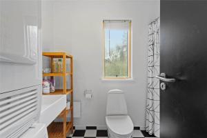 a bathroom with a toilet and a black door at 1306-Stege-Kaerhogevej-64 in Stege