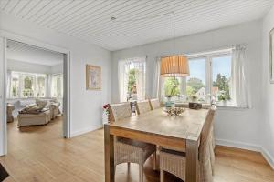 a dining room with a table and some chairs at 4033-Stege-Kirkebakken-33 in Stege +15 photos