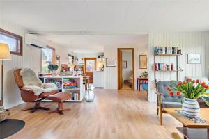 a living room with a chair and a couch at R607-Rodvig-Stevns-Thormodsvej-7 in Rødvig +16 photos
