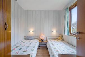 a bedroom with two beds and a teddy bear on a table at R607-Rodvig-Stevns-Thormodsvej-7 in Rødvig
