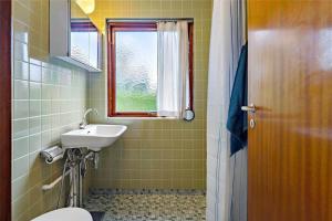 a bathroom with a sink and a toilet and a window at R607-Rodvig-Stevns-Thormodsvej-7 in Rødvig