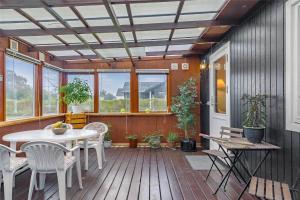 a patio with a table and chairs on a deck at R607-Rodvig-Stevns-Thormodsvej-7 in Rødvig