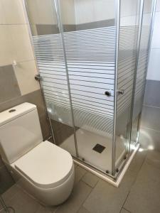 a bathroom with a toilet and a shower at Residenza Frontemura in Montefalco +26 photos