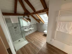 a bathroom with two sinks and a toilet in a room at TRUST Boardinghouse in Stuttgart +81 photos