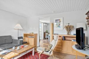 a living room with a couch and a table at 4019-Stege-Udbyvej-15 in Stege