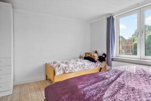 two stuffed animals sitting on a bed in a bedroom at 4019-Stege-Udbyvej-15 in Stege