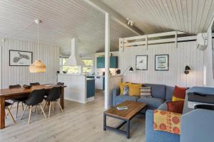 a living room with a blue couch and a table at 1080-Stege-Berberisvej-48 in Stege
