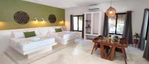 ein Wohnzimmer mit Sofa und Tisch in der Unterkunft Valentina Holbox by Las Flores Vacation Rentals in Holbox