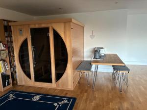 a room with a table and a counter with a coffee maker at Retreat in Cardiff