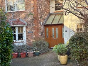 a brick house with a brown door and some plants at Retreat in Cardiff +5 photos